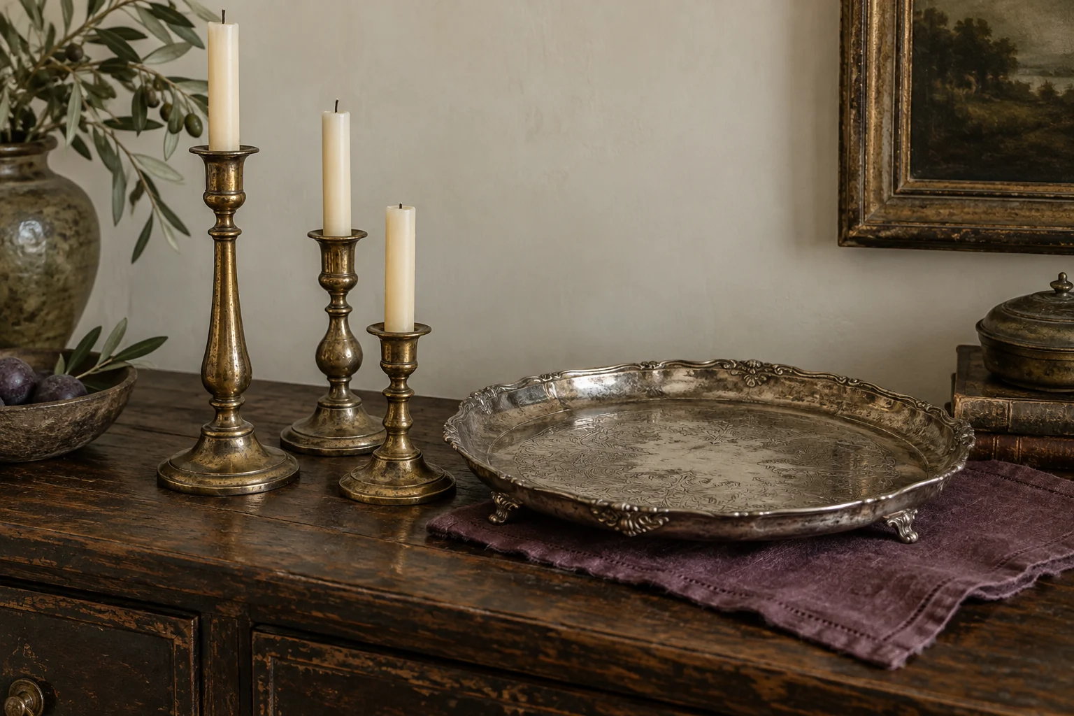 Illustrative aged metal candlesticks and a decorative tray