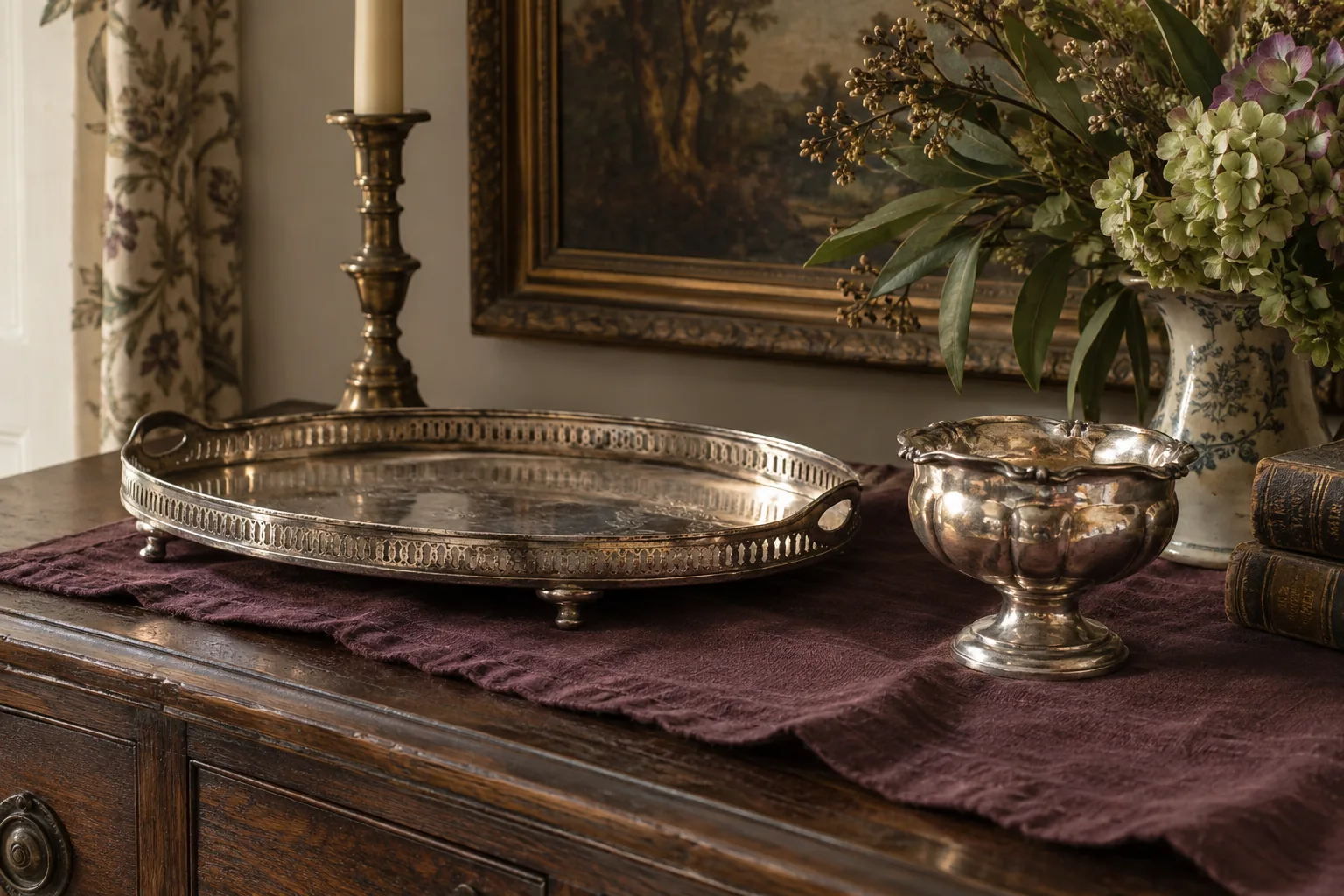 A silver-coloured tray and footed bowl on a plum cloth.